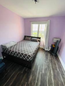 a bedroom with a bed and a window at Jazzy Home Stay in Mississauga