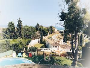 an external view of a house with a swimming pool at Finca Villordo Villa Tranquila in Benalmádena