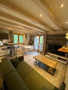 un soggiorno con divano e tavolo di Appartement La Suite du Kandahar à Chamonix a Chamonix-Mont-Blanc