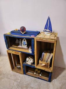 a small wooden cabinet with a sail on top of it at Kot Nu - Beach Themed Apartment - 3 mins walk from the sea in Flic-en-Flac