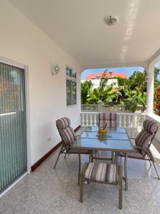 a dining room with a table and chairs at Didi's Dream apartments in Anse Kerlan