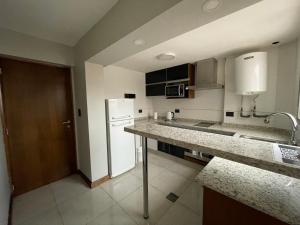 a kitchen with a counter top and a refrigerator at Departamento a estrenar. A 20 metros de peatonal in Mendoza