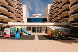 a playground in the middle of a mall with a building at Peñiscola Plaza Suites in Peñíscola