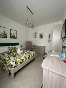 a bedroom with a bed and a desk in it at Colibri B&B in Sciacca