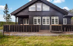 a house with a wooden fence in front of it at Lovely Home In Passebekk With Wifi in Omholt