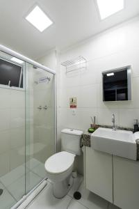 a bathroom with a toilet and a sink and a shower at Rover 1011 Centro in Sao Paulo