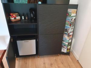 a black refrigerator with a small white door at Immerloopark B&B in Arnhem