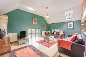 a living room with a couch and a tv at Nine Ladies in Matlock