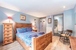 a bedroom with a bed and a bathroom at Nine Ladies in Matlock