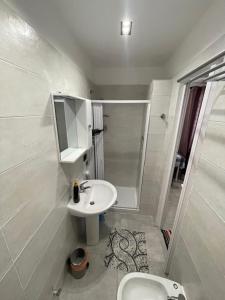 a white bathroom with a sink and a shower at Tufaro B&B in Macerata Campania