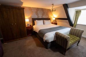 a hotel room with a bed and a chair at Antelope by Greene King Inns in Poole +45 photos