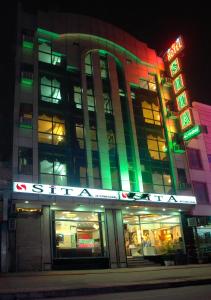 a building with a neon sign in front of it at Hotel Sita International in New Delhi