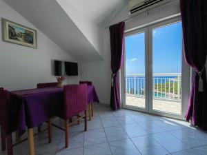 a dining room with a table and a view of the ocean at Apartments Marija Magdalena in Hvar