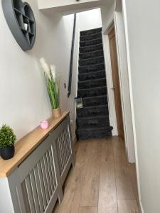 un pasillo con una escalera en una casa en Tredegar property, unique location with luxury bedroom, bathroom & dining room en Sirhowy