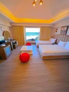 a hotel room with two beds and a large window at Luxury Seafront Pool Villa - 3 Stories & Roof floor - All Master Bedrooms in Hurghada +31 photos