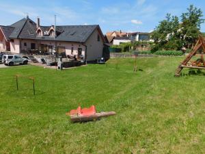 un parque infantil en un patio con una casa en Apartmánový Penzión Bojnice en Bojnice