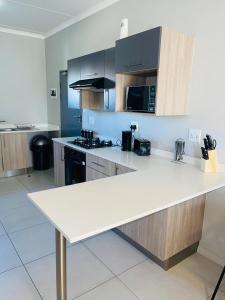 a kitchen with a white counter top in a room at Dubai 2 in Midrand