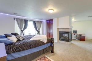 a bedroom with a bed and a fireplace at Spacious Vacation Rental Near Utah Lake! in Lehi