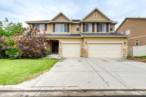 a house with two garage doors on a driveway at Spacious Vacation Rental Near Utah Lake! in Lehi