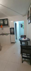 a kitchen with a table and a washer and dryer at Encantadora casa con ambiente guajiro #3 in Barranquilla