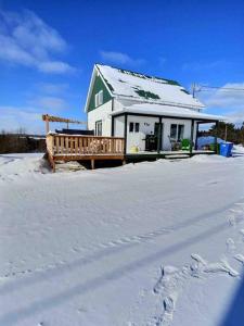 a house in the snow with footprints in the snow at Chez Dorance in Saint-Gabriel