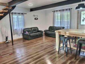 a living room with a table and a couch at Chez Dorance in Saint-Gabriel