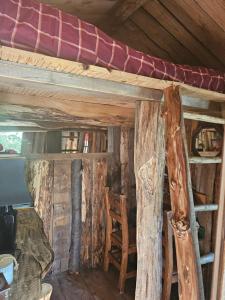 a room with a bunk bed in a log cabin at Cabane insolite in Saint-Germain-de-Calberte