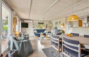 a living room with a table and chairs at Amazing Home In Hemmet With Wifi in Hemmet