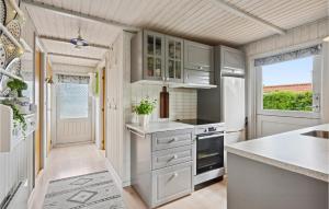 a kitchen with white cabinets and a large window at Amazing Home In Hemmet With Wifi in Hemmet