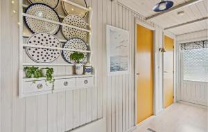 a hallway with plates on a wall at Amazing Home In Hemmet With Wifi in Hemmet +13 photos