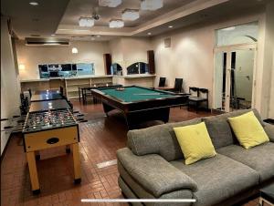 a living room with a couch and a pool table at Ryokan Yuzawa - Vacation STAY 14222v in Yuzawa