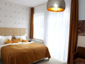 a bedroom with a bed and a large window at Arthotel in Bad Pyrmont