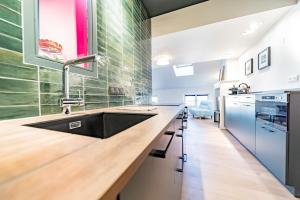 a kitchen with a sink and a counter at Le petit Garet -charmant 2 pers-Terreaux in Lyon