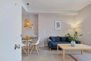 a living room with a blue couch and a table at Angelica's Home Fuengirola in Fuengirola +30 photos