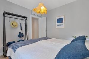 a bedroom with a large bed and a chandelier at Angelica's Home Fuengirola in Fuengirola