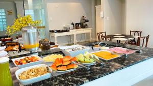 a buffet of food on a counter in a kitchen at Itajaí Express Residence in Itajaí