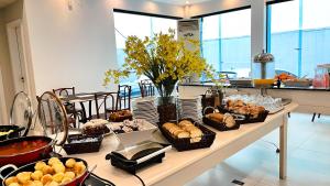 a table with many different types of food on it at Itajaí Express Residence in Itajaí