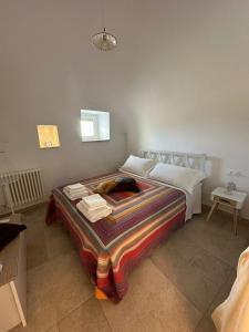 a bedroom with a bed with a blanket on it at Trullo Gnoffa in La Correggia +52 photos