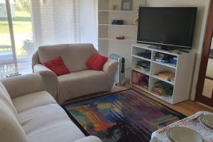 a living room with a couch and a flat screen tv at Beautiful Falcon Bay - B & B Accommodation in Wannanup