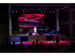 a group of musicians on a stage in front of a crowd at Swandor Hotels & Resorts - Kemer in Kemer