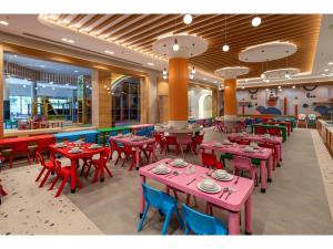 a restaurant with red and blue tables and chairs at Swandor Hotels & Resorts - Kemer in Kemer