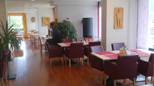 a dining room with tables and chairs and a unintention at Hotel Bergfrieden in Bad Wildbad