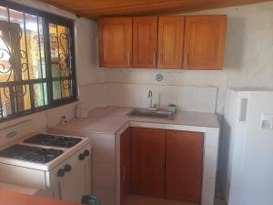 a small kitchen with a stove and a sink at Cabaña La Esperanza in Paipa