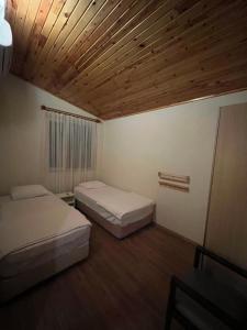 キラリにあるキバラ ホテルの木製の天井が特徴のベッドルーム1室(ベッド2台付)
