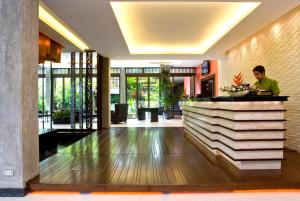 a man standing at a counter in a lobby at Club Wyndham Sea Pearl Phuket in Patong Beach +45 photos