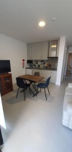 un soggiorno con tavolo e sedie e una cucina di Arrenquinha Guesthouse 2 a Ponta Delgada