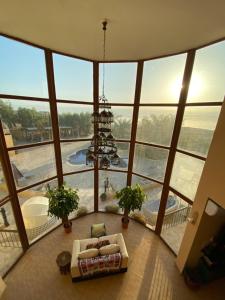 a living room with a chandelier in a large building at The Precious Villa in Sowayma