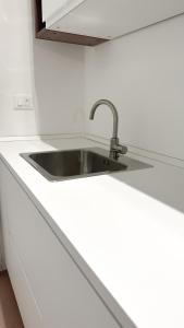 a kitchen counter with a sink in a kitchen at Atelier Rimini - Affitti Brevi Italia in Rimini