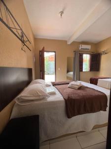a bedroom with a large bed and a window at Hotel Pinto Martins in Camocim