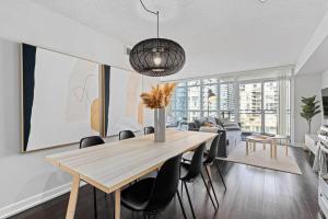 a dining room with a wooden table and chairs at Work From home with Parking WIFI and CN Tower View in Toronto